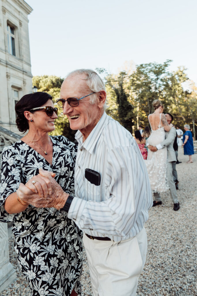 Wedding guests dancing together.