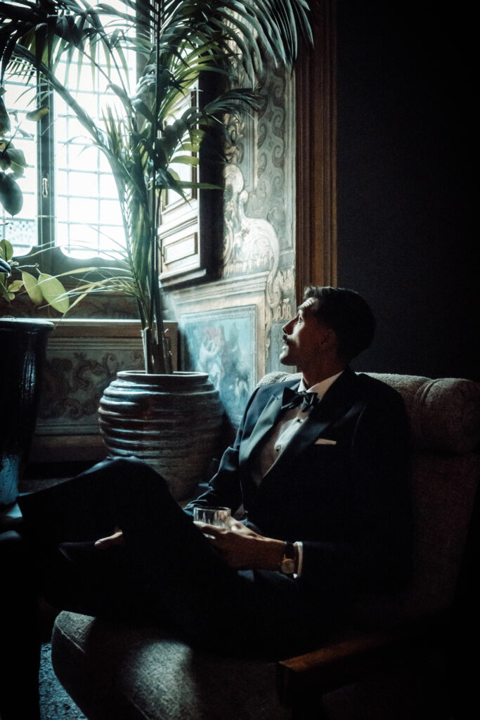 Groom sat looking up at a window.