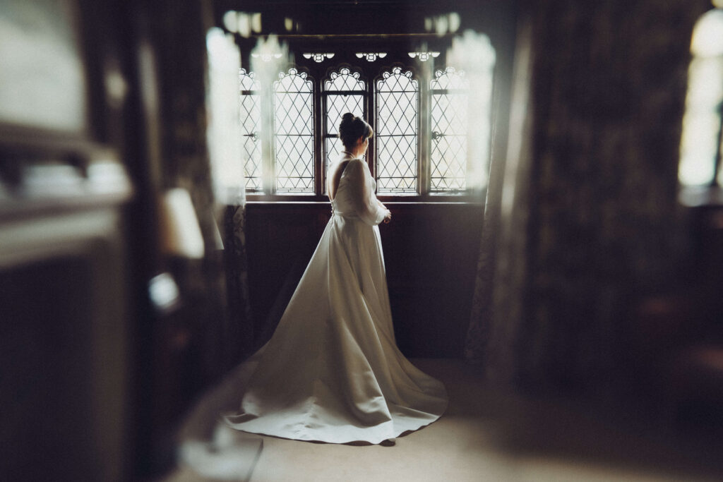 Bride looking out the window in one of the Hever Castle rooms.