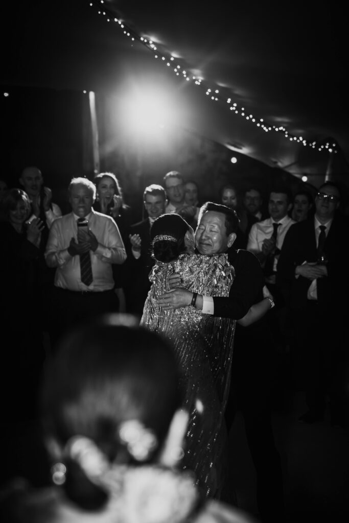 Black and white photograph of a father and daughter dancing at a wedding reception