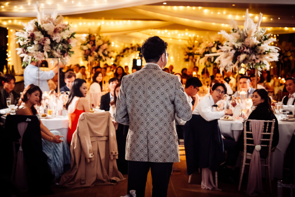 Man giving a speech during a wedding reception.