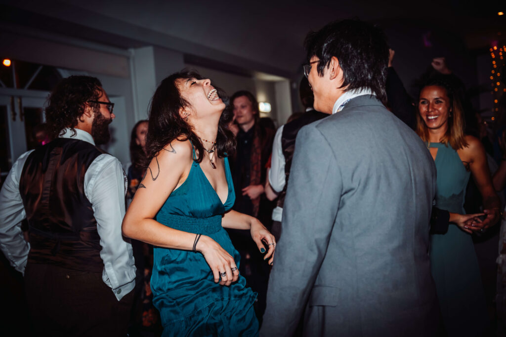 Wedding guests dancing together during the evening reception.