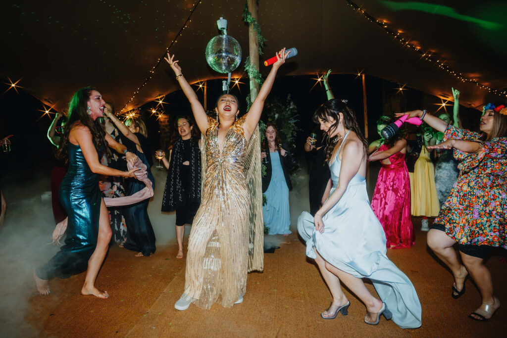 Bride dancing with wedding guests on the dance floor.