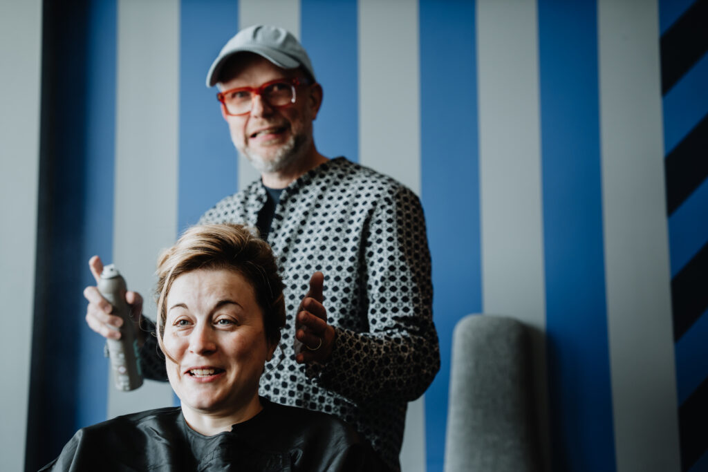 Bride having her hair styled in bridal suite.