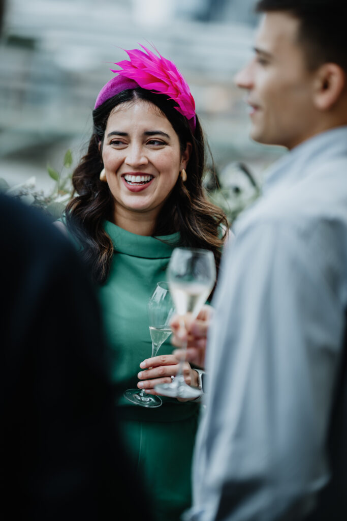 Wedding guests laughing together during the drinks reception at The Swan London wedding. 