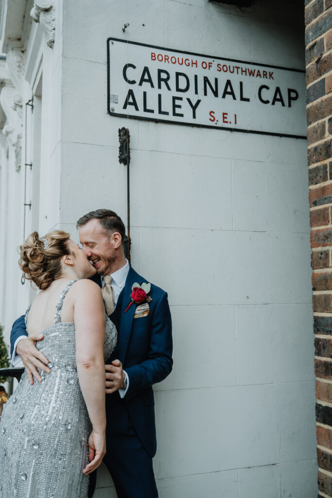 couple embracing and smiling at each other along the London Thames during a private wedding photography session. Captured by a UK luxury wedding photographer