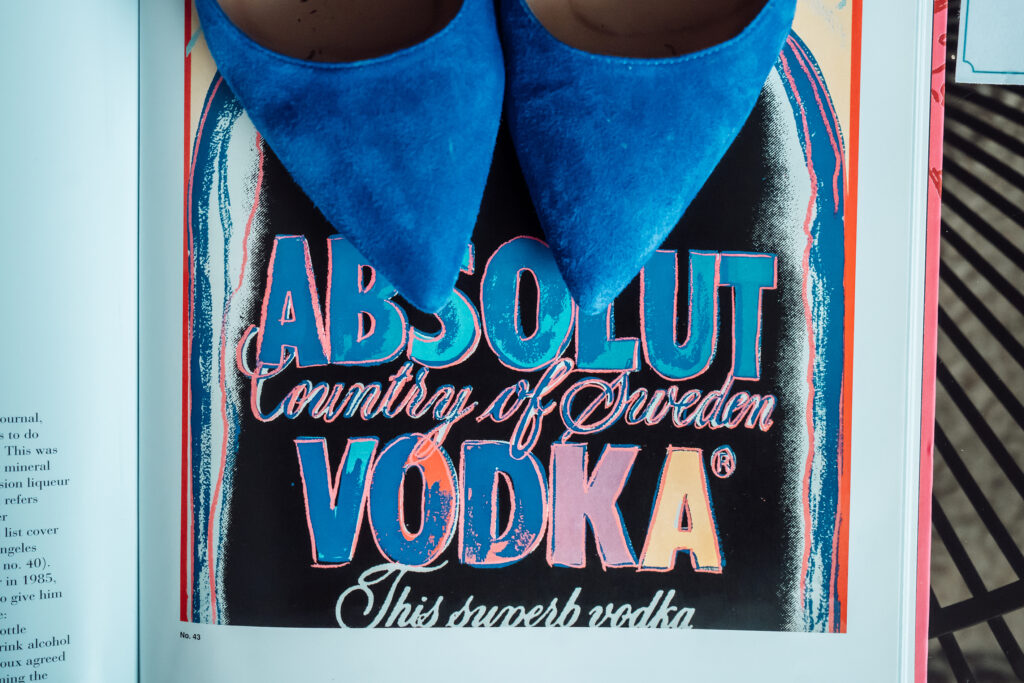 n open book on a images of Andy Warhol's vodka painting.