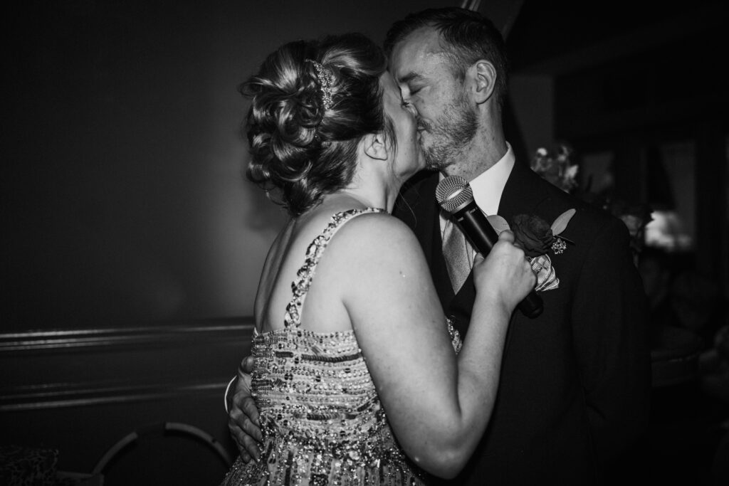 black and white photo of the couple kissing during a wedding celebration at Swan London. 