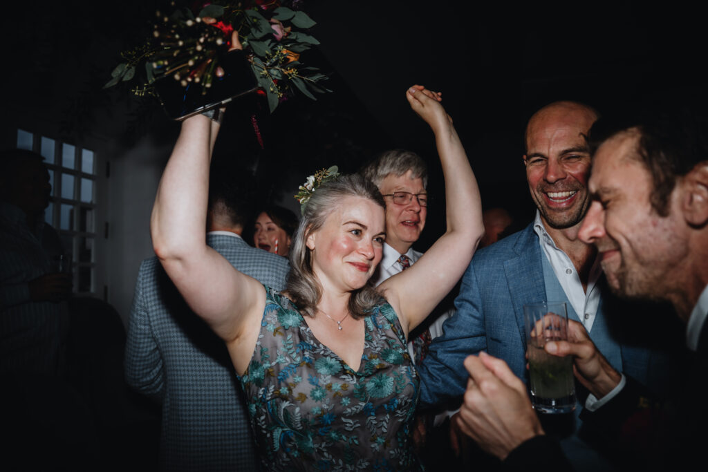candid photo of a wedding guest dancing during a wedding celebration at Swan London. 