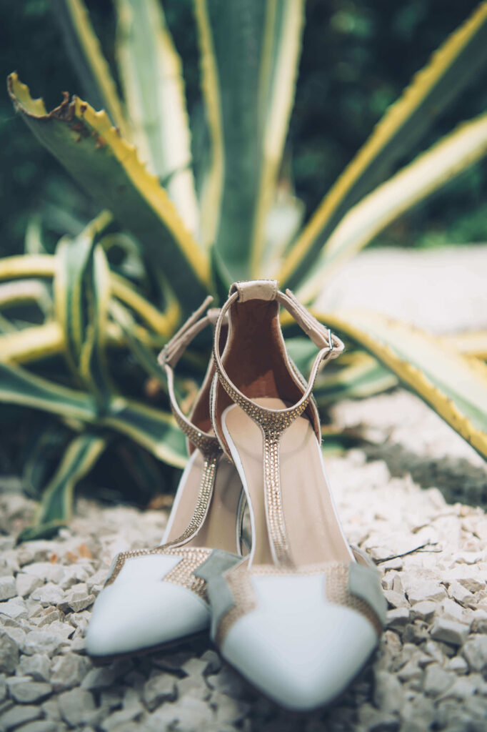 Close-up of the bride's shoes in an outdoor setting.