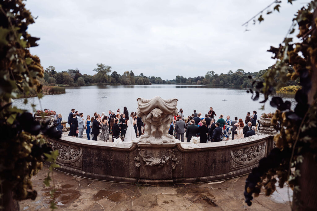 Wide shot of wedding party socialising at Hever castle 'Loggia'.
[Teri V Photography Wedding Timeline Guide]