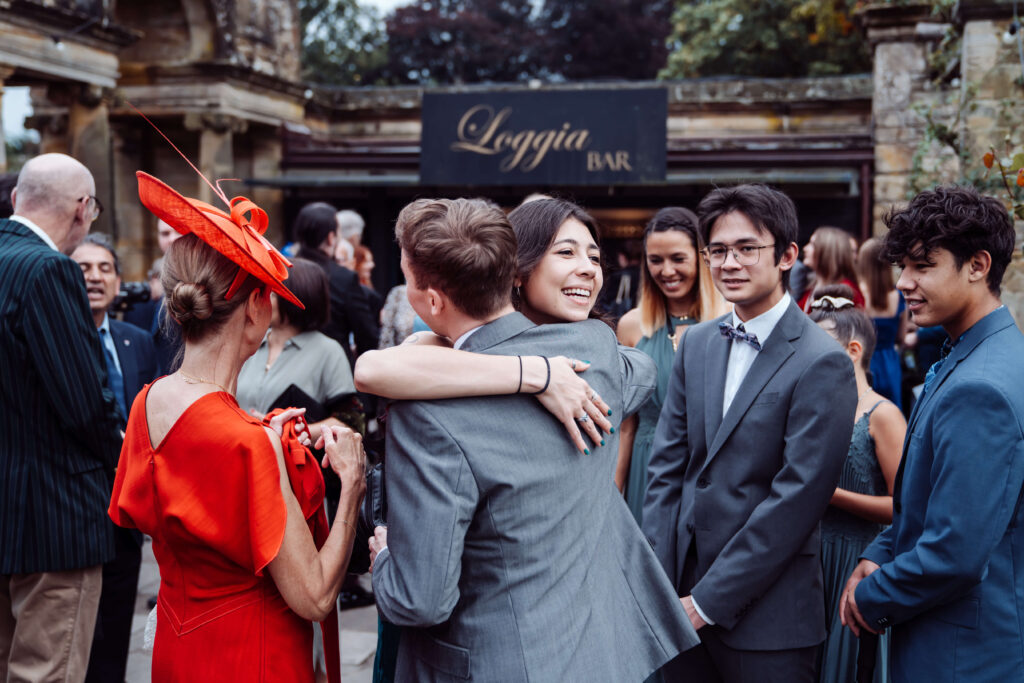 Photo of wedding party socialising and embracing